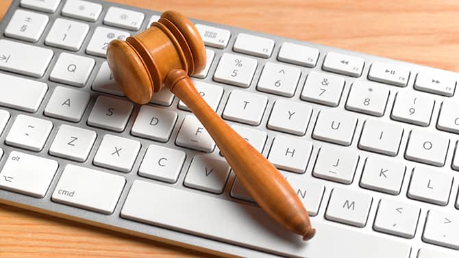 Judge's gavel over a white keyboard in an office.